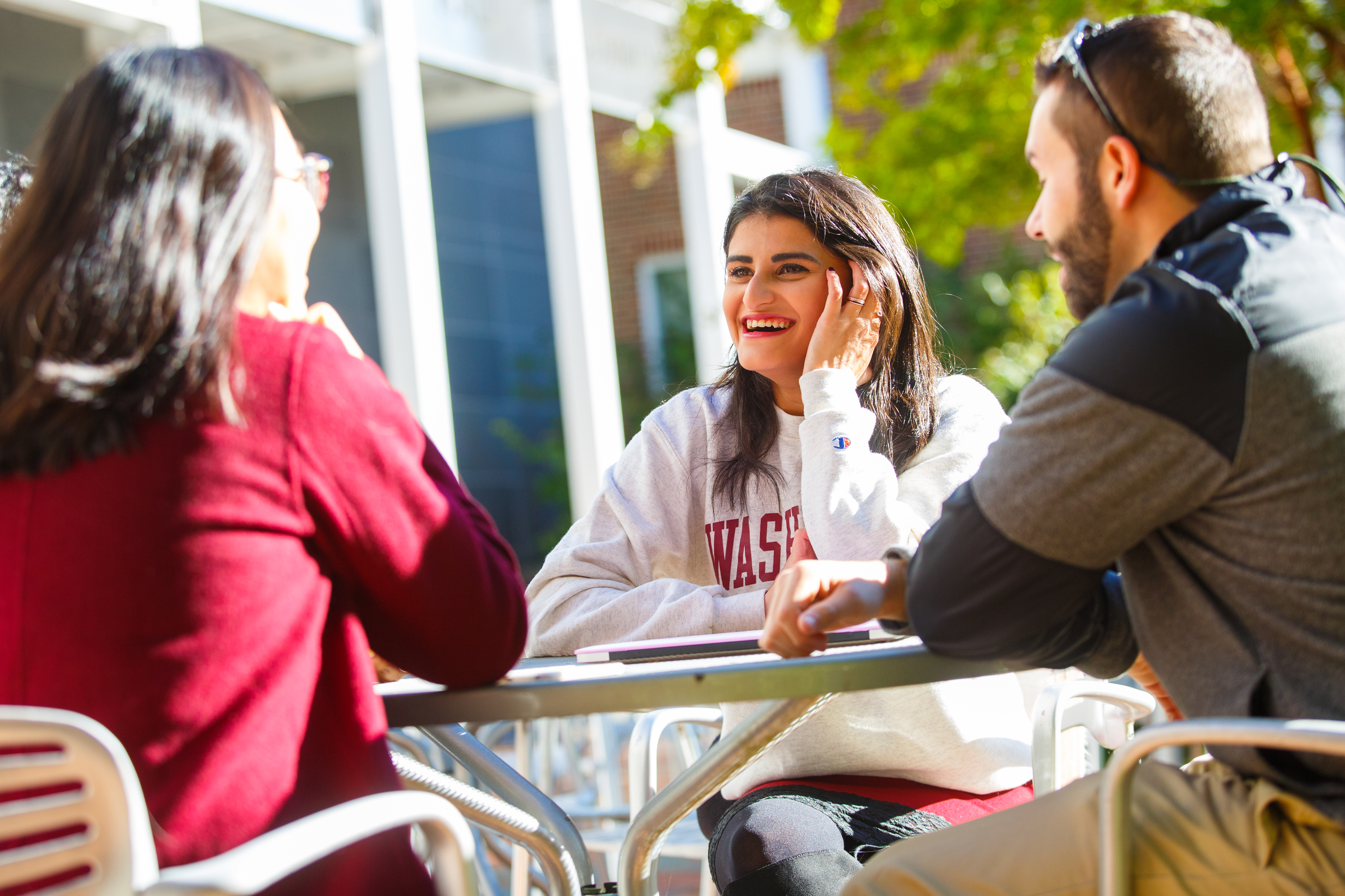 Students holding a conversation outside of the library