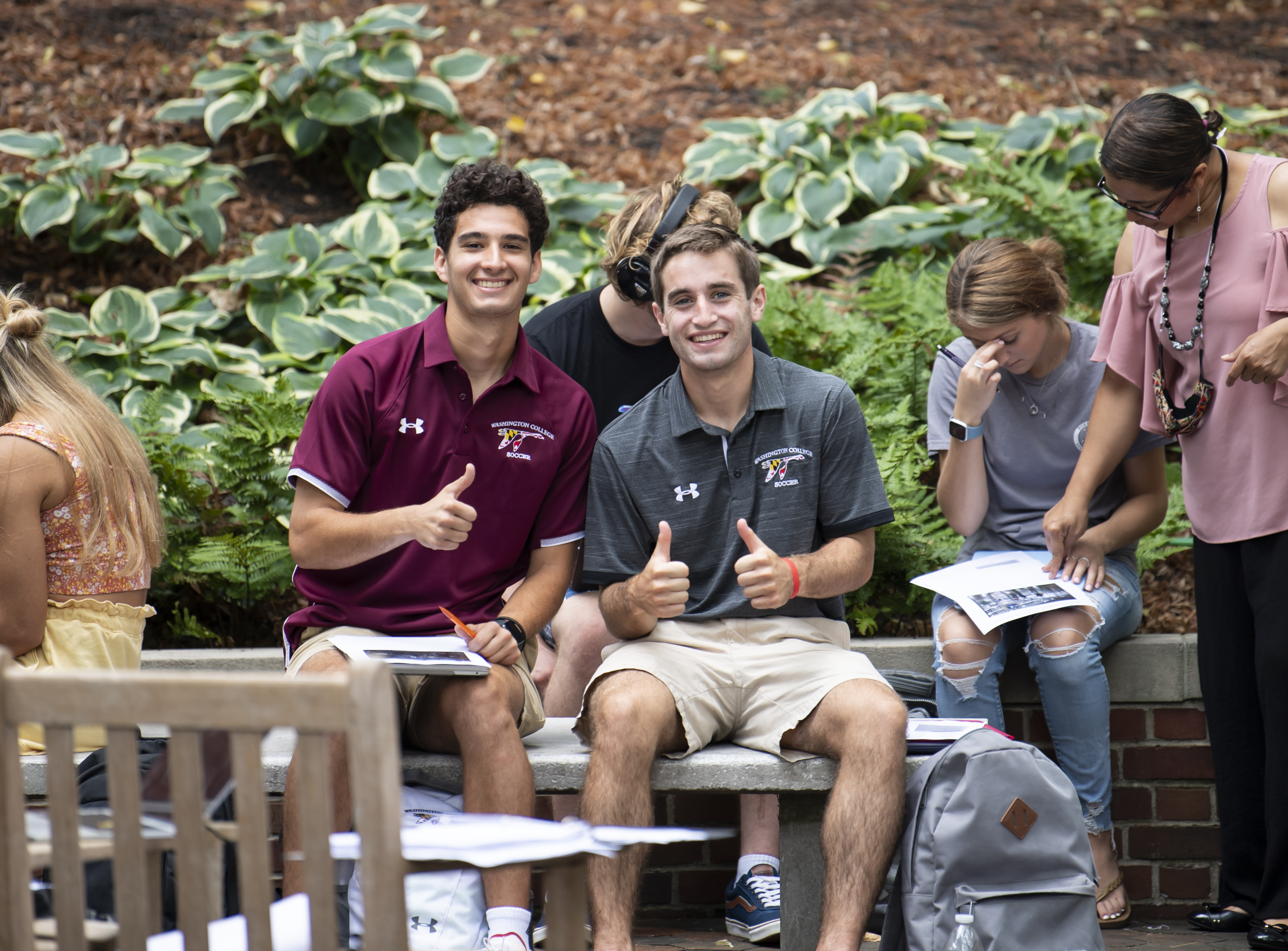 Washington College students smiling and giving thumbs-up signs