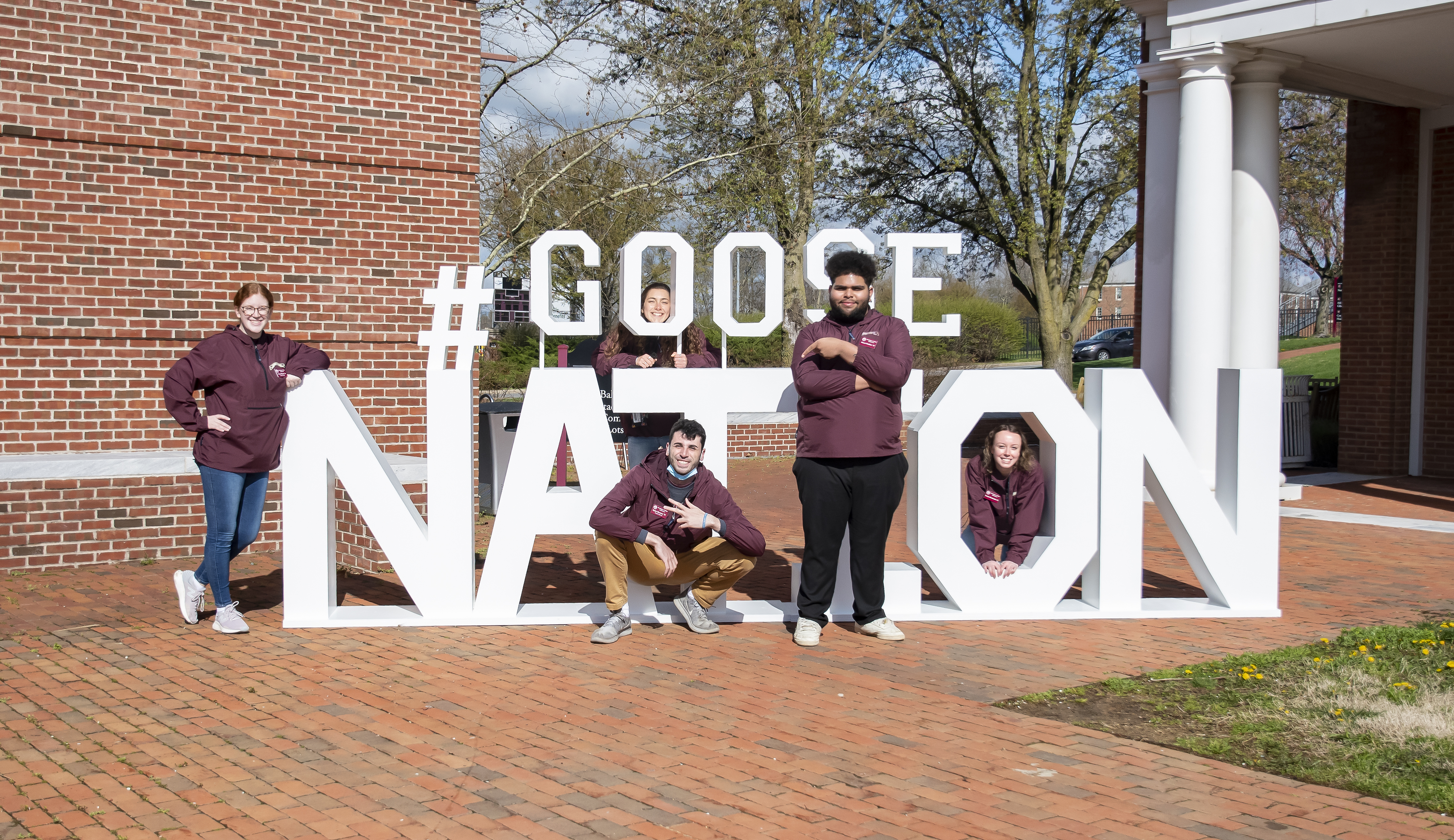 Students posing in from of Goose Nation Sign