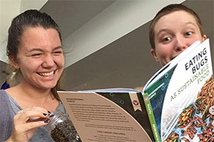 Two students looking at a book