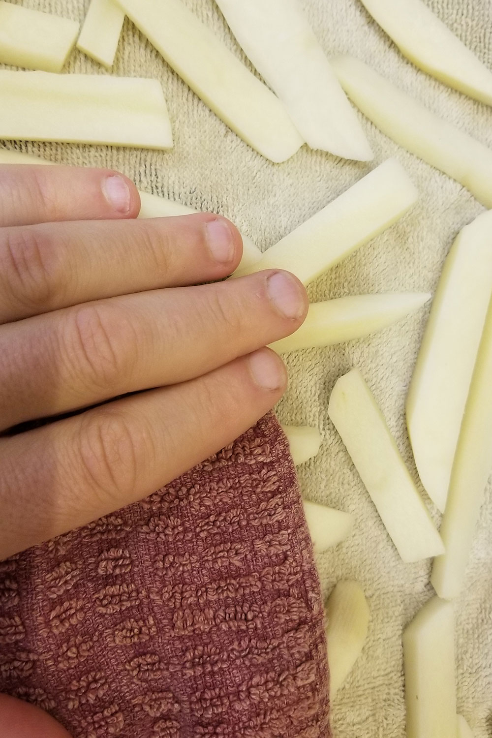 Pat potatoes dry with a clean dishcloth if making french fries. 