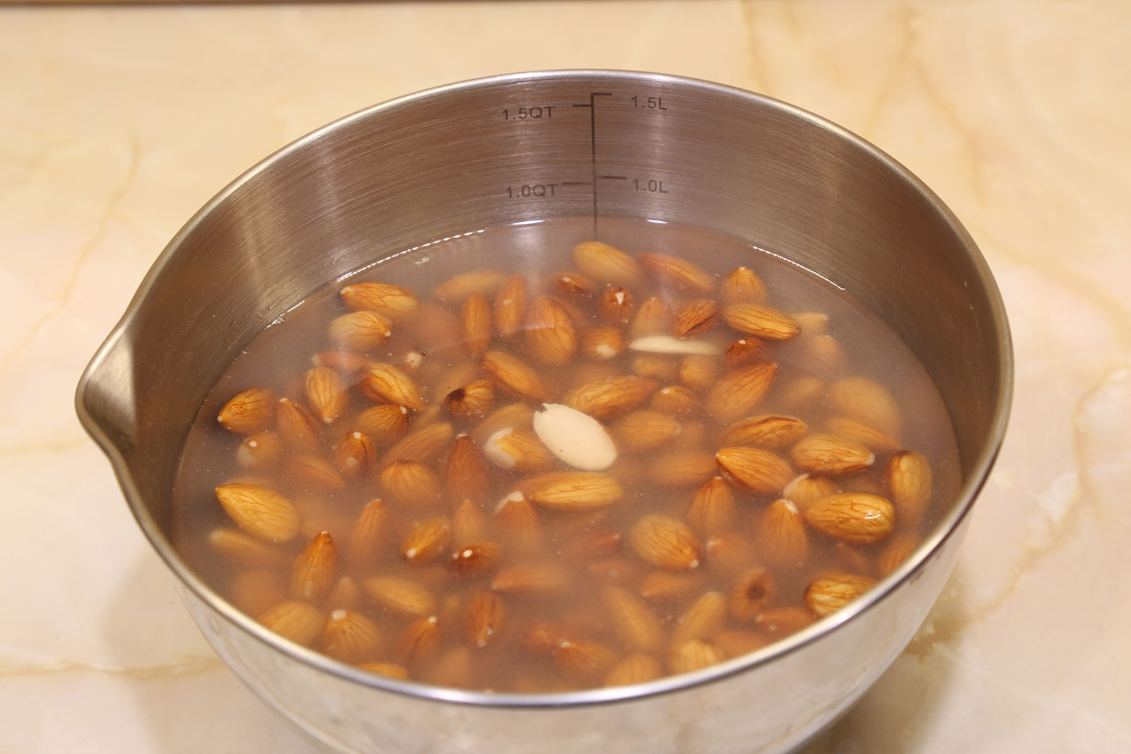 Strain the cloudy water from the almonds and rinse with fresh water.