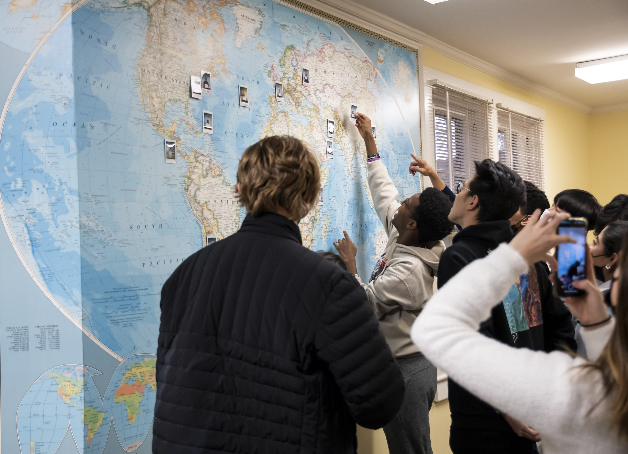 students in front of world map