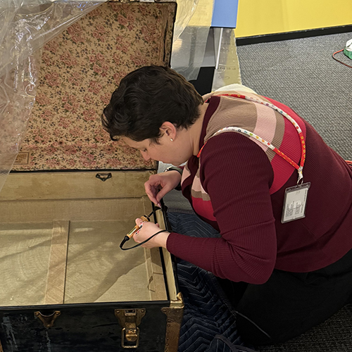 Rebecca Beyth works on restoring an antique chest