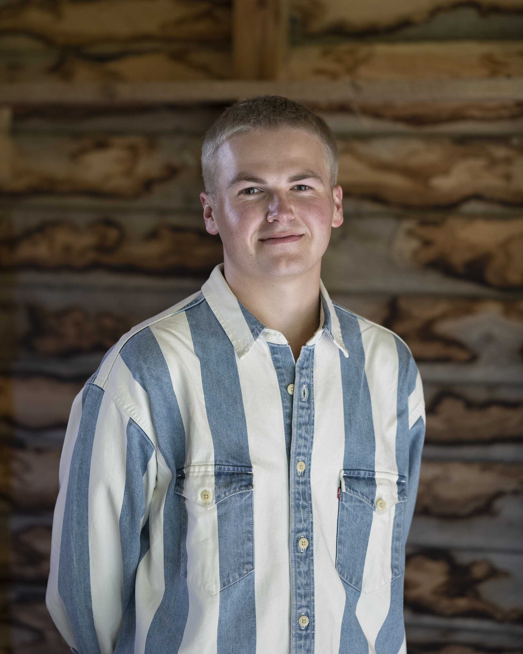 Photo of Justin Nash, wearing a white striped denim shirt