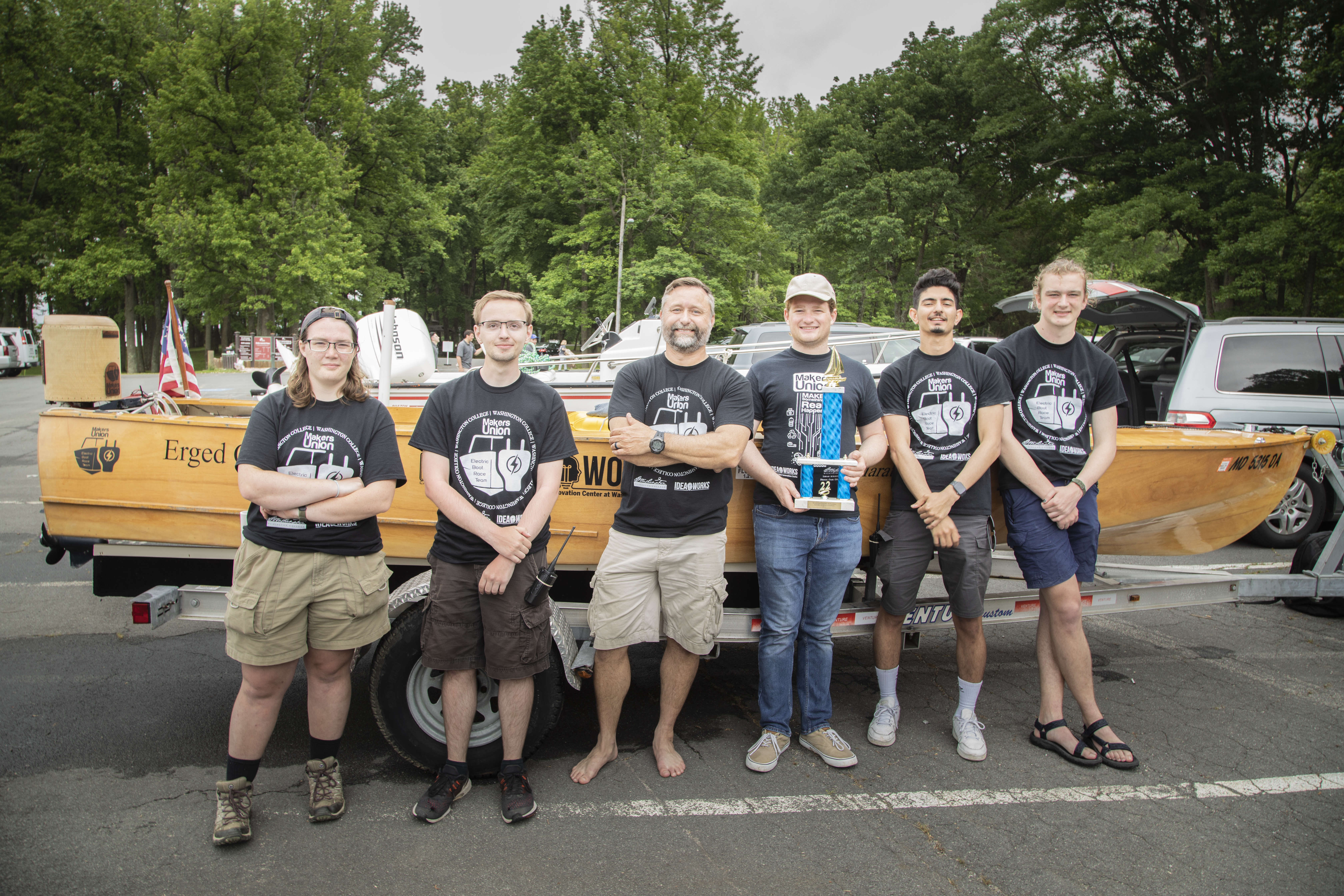 Members of the Electric Race Boat Team smiling with their trophy