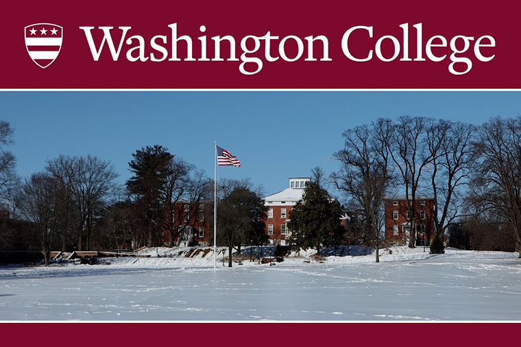 Photo of the American flag flying above a snowy campus Green