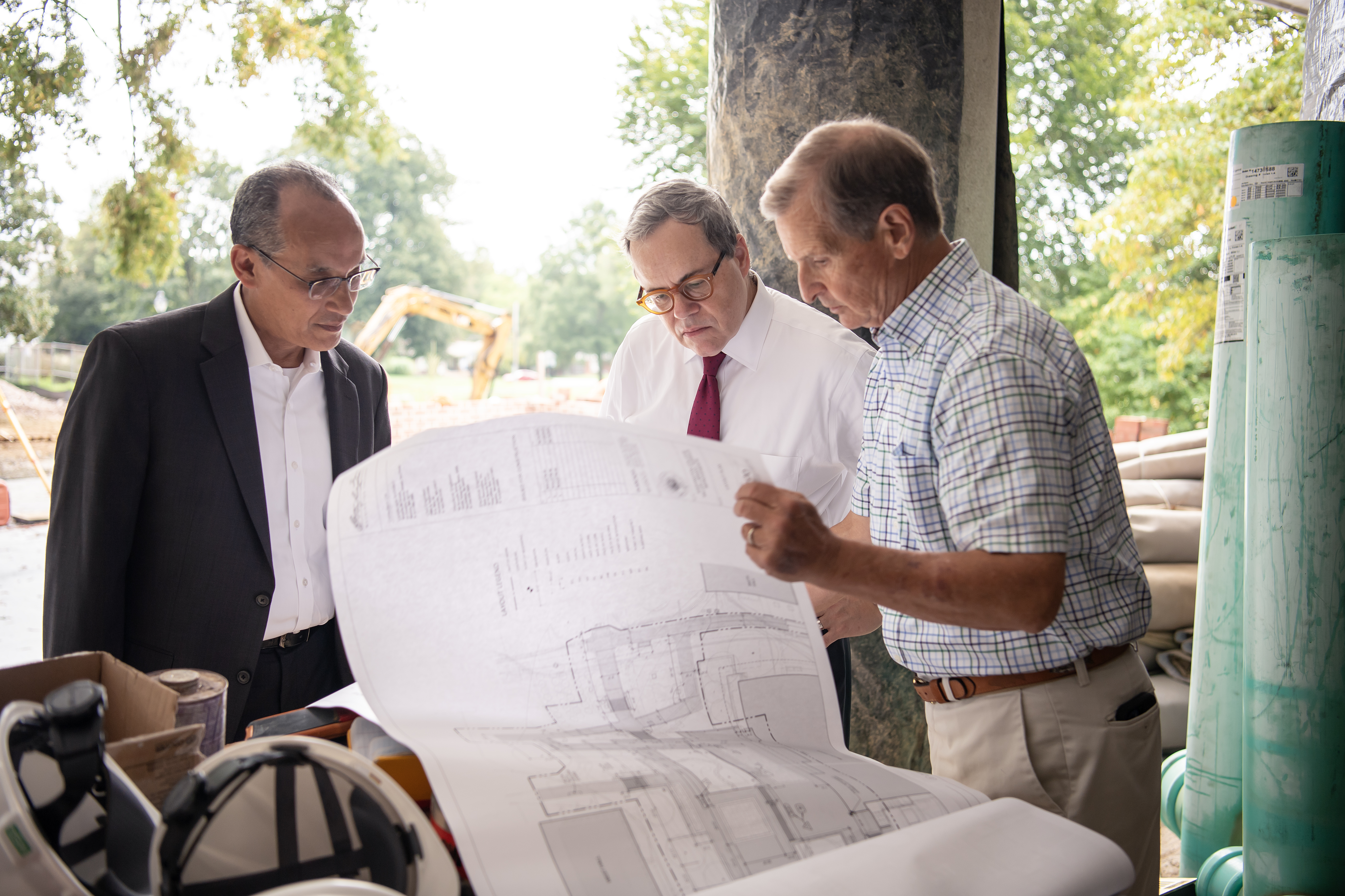 Ed Patrick, Mike Sosulski, and Vic Costa review plans for the library terrace renovation