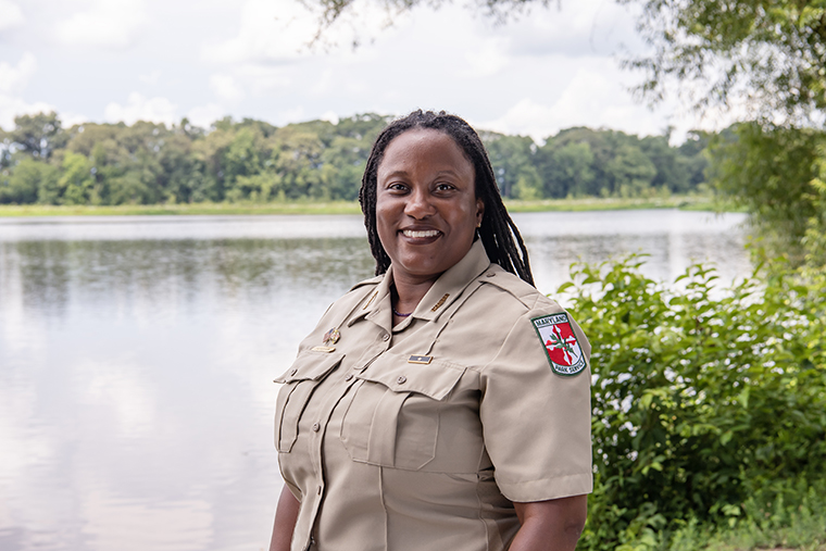 Superintendent Angela Crenshaw '04 stands in front of a pond at Tuckahoe State Park.