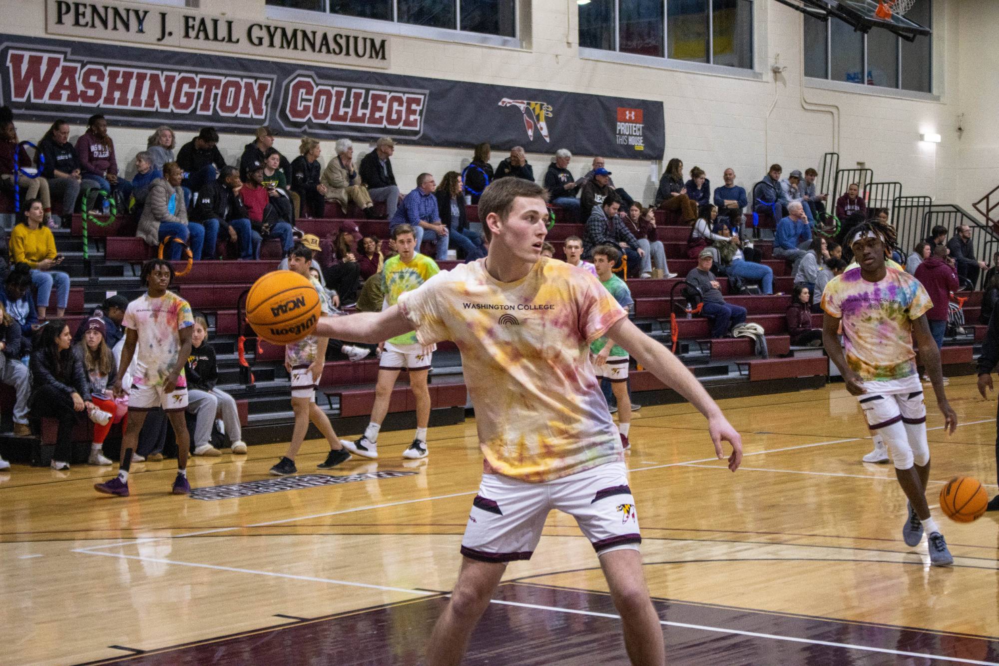 Washington College men's basketball team runs drills while wearing tie-dye shirts