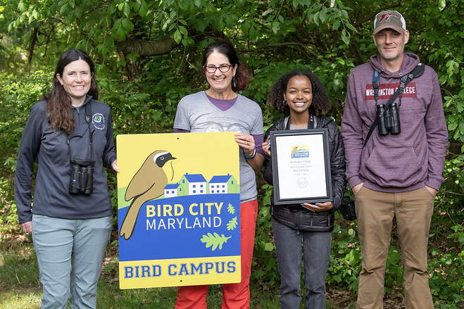 Washington College staff pose with the Bird Campus plaque and program coordinator from the Maryland Bird Conservation Partnership.