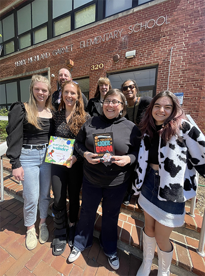 The Washington College research team poses outside Chestertown's Garnet Elementary School with the books distributed through the Busload of Books tour.