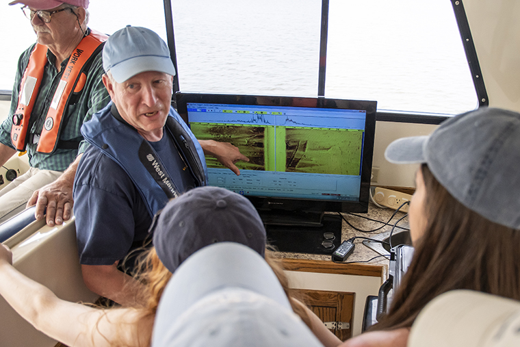 Doug Levin explains the use of sonar for underwater research to students aboard the College’s research vessel, the R/V Callinectes.