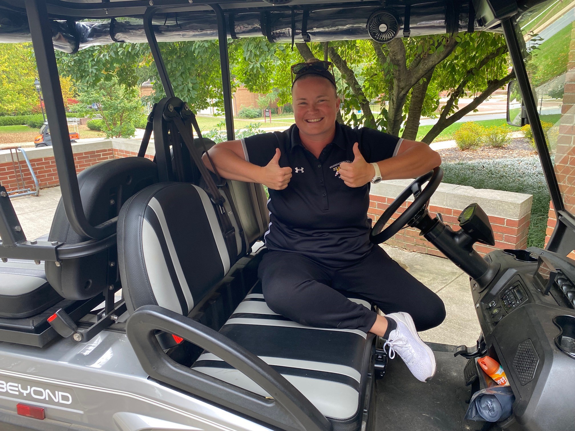 Head Softball Coach Sally Snover sits in her golf cart
