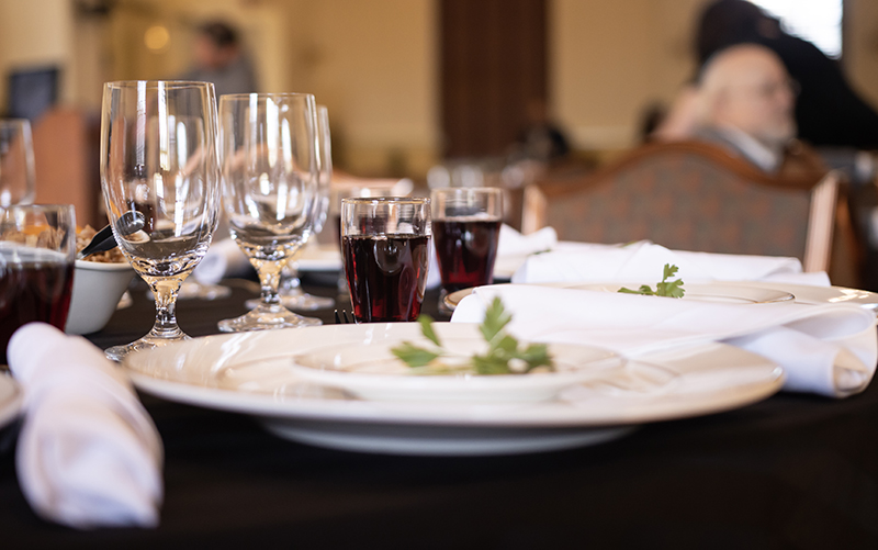 close up of the table setting showing the wine (grape juice) and bitter herb (parsley)