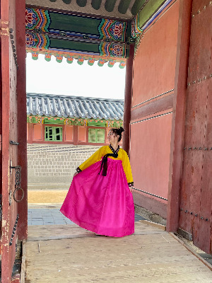 Sammy Segeda '23 stands in a doorway in South Korea in traditional dress.