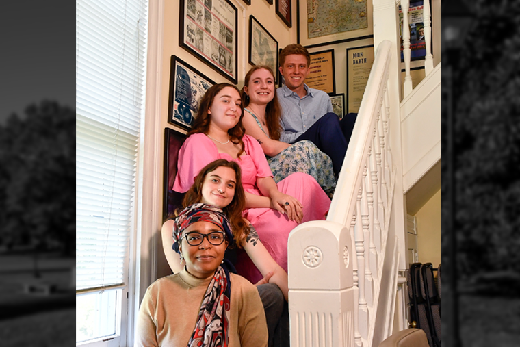 The five finalists for the 2023 Sophie Kerr Prize sit on the stairs in the Rose O'Neill Literary House.