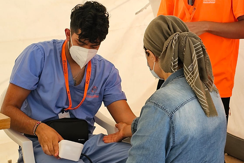 Jay Dadhania '24 checks a patient during his work with International Medical Relief in Turkey.