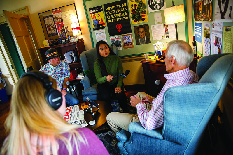 Three Washington College students collect oral history by recording a man speaking with them.