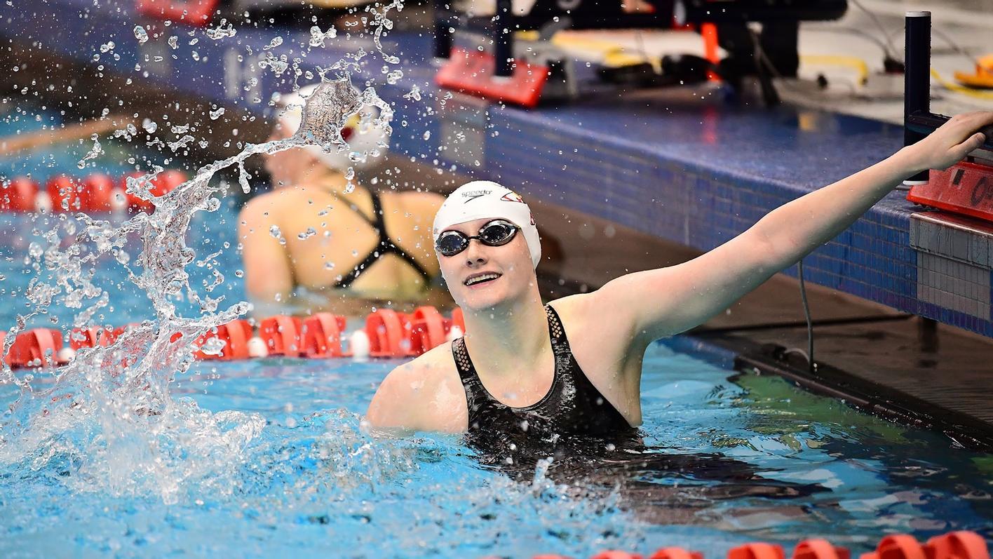 A Washington College swimmer finishes her race
