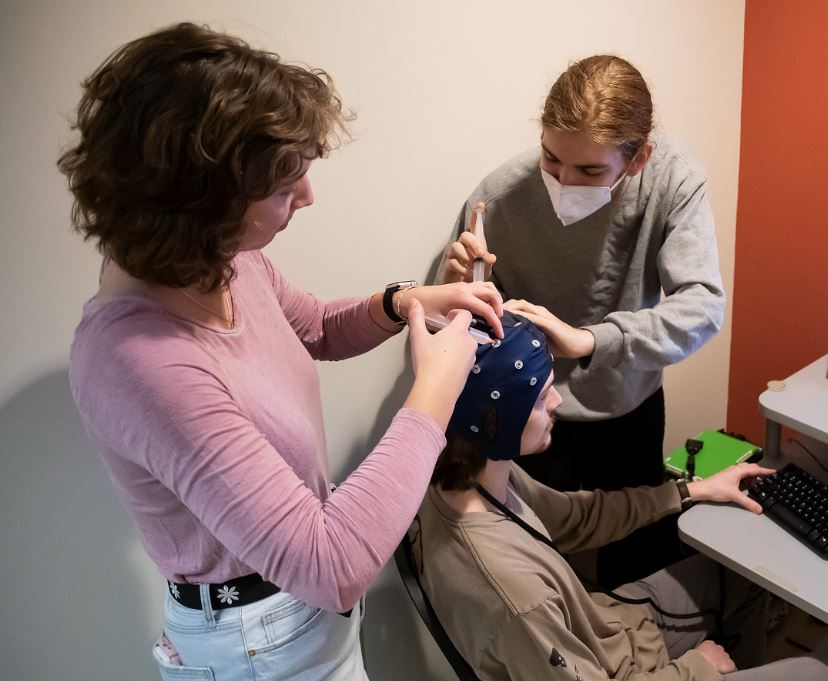 Students preparing an EEG participant