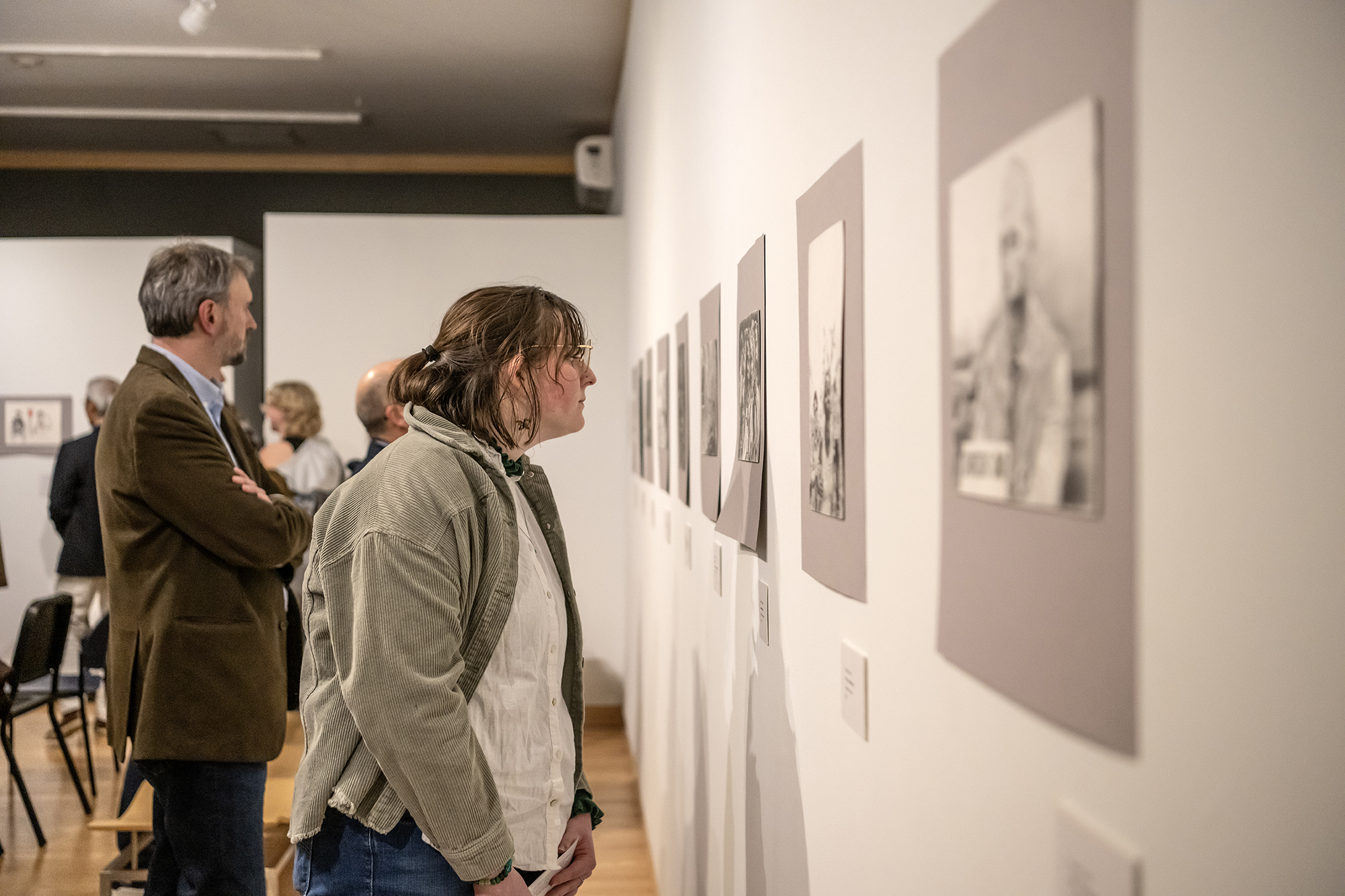 student looking at work in the kohl gallery