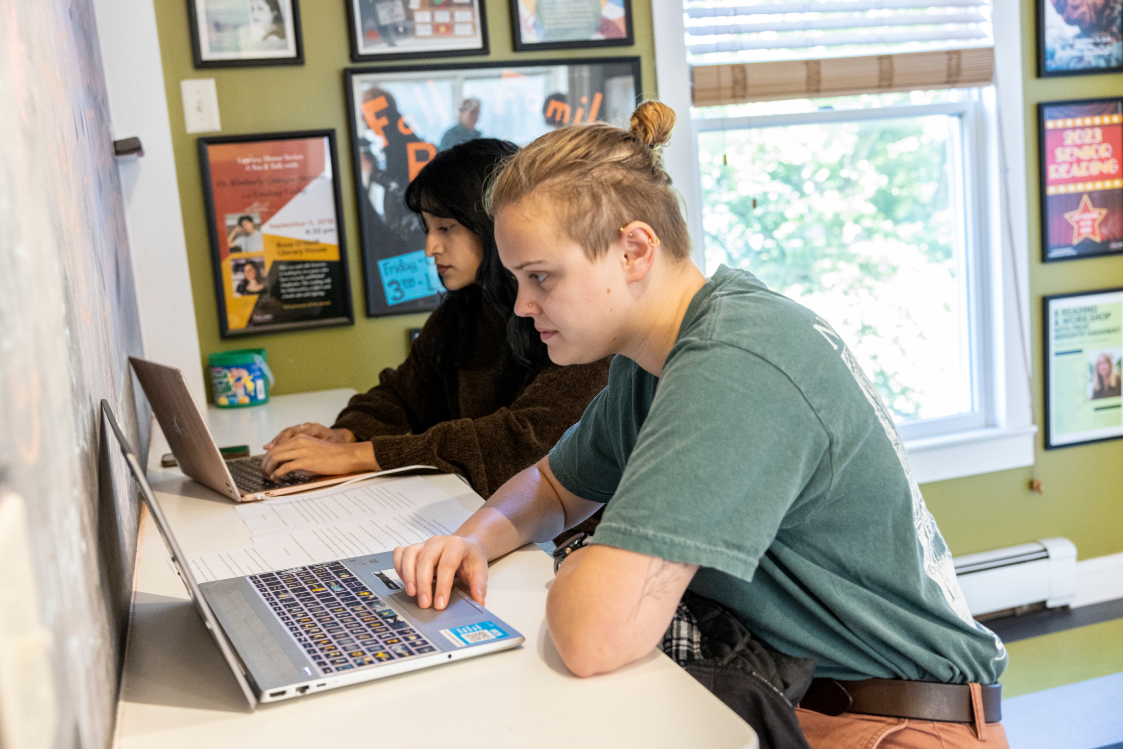 Two Washington College students working on their computers in the Rose O'Neill Literary House, a Washington College Center of Excellence