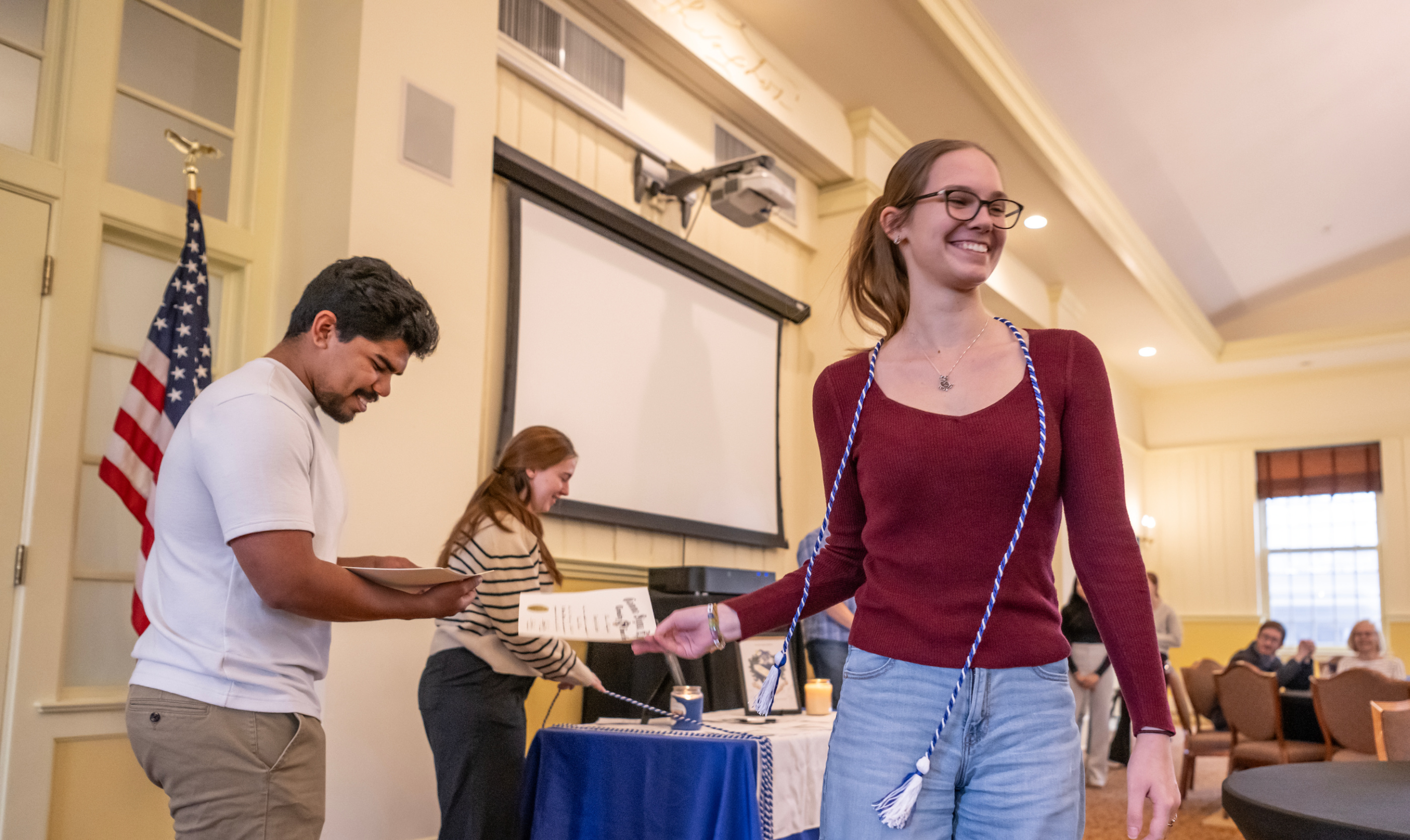 Honor student receiving graduation cord and certificate