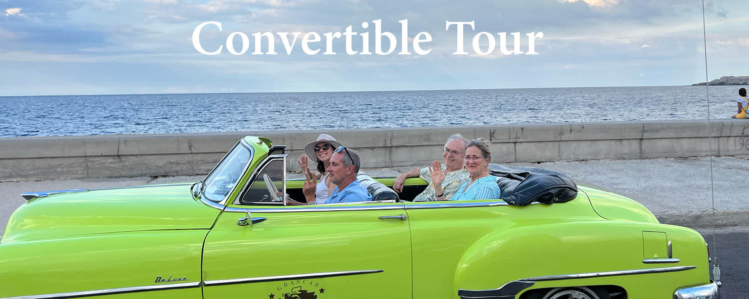 Four travelers riding in a lime green convertable along the beach