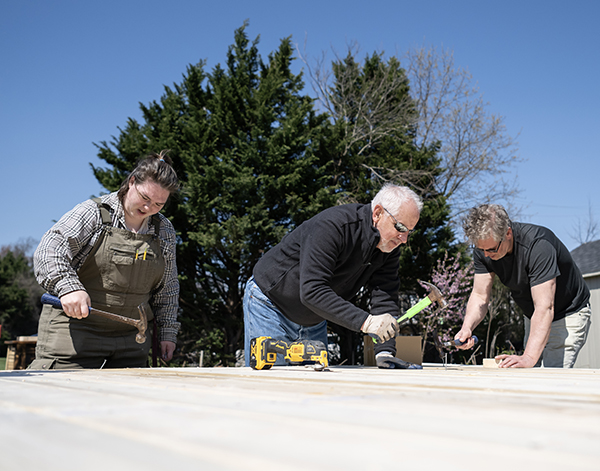 A Washington College student and two Academy of Lifelong Learning students work on the poetry garden