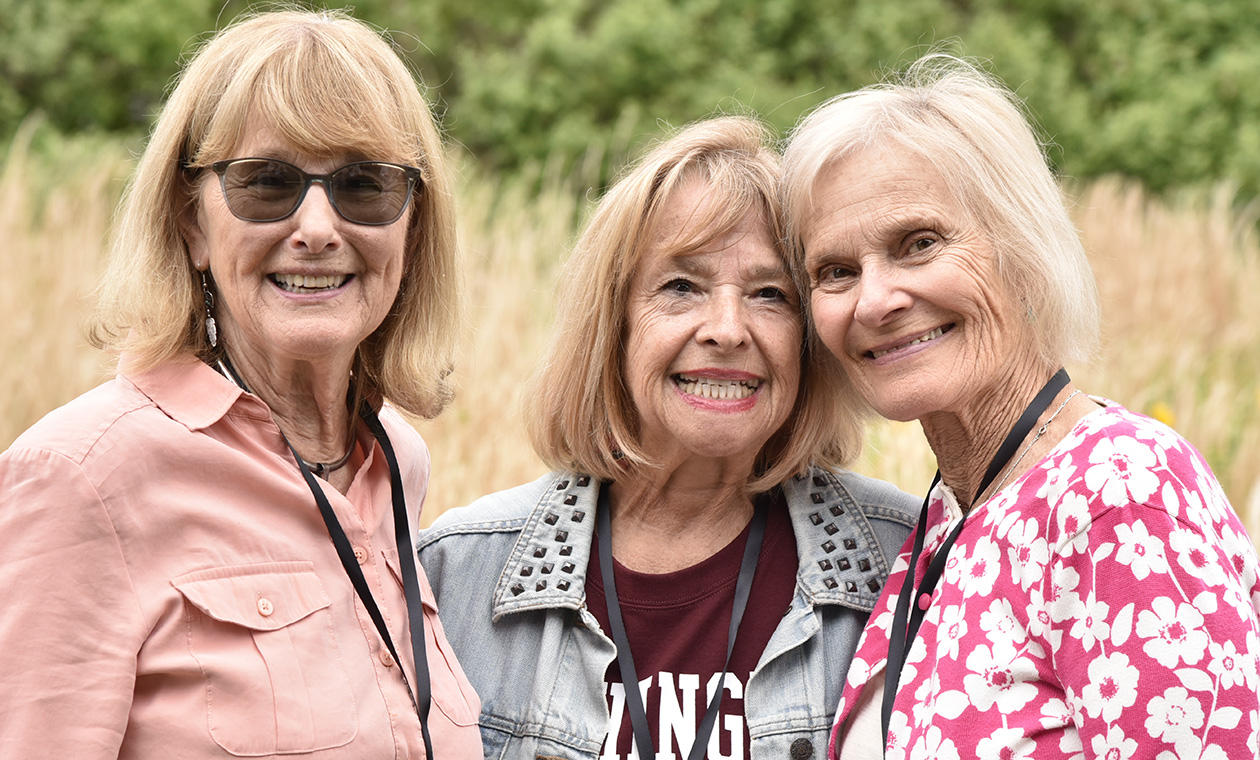 Three alumnae pose for the camera