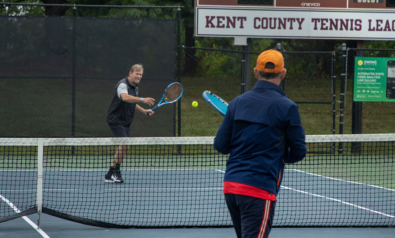 Two alumni play a game of tennis