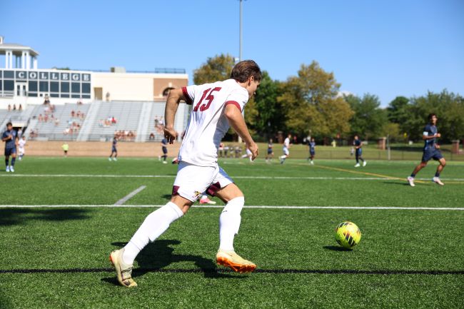 men's soccer player kicking a ball