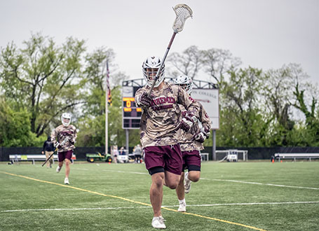 man playing lacrosse in camouflage 