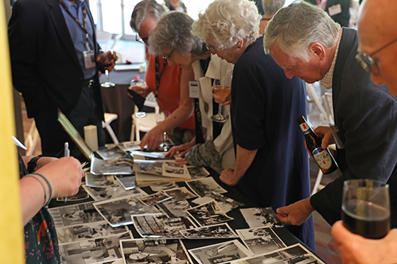 Alums look at old photos during an OWLs dinner