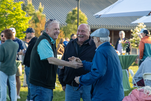 men laughing at river party