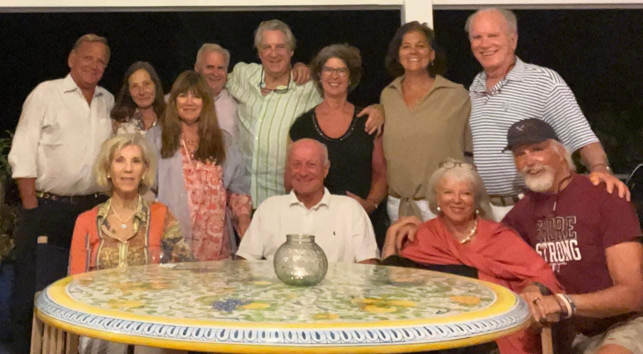 group of people sitting behind a table