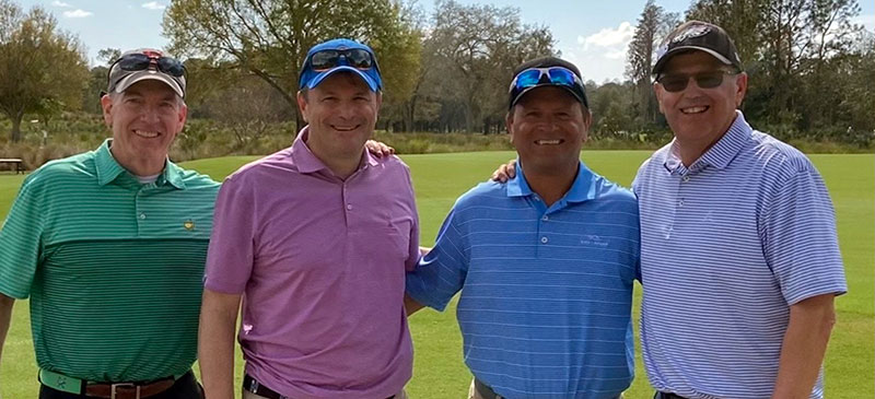Four men at a golf club