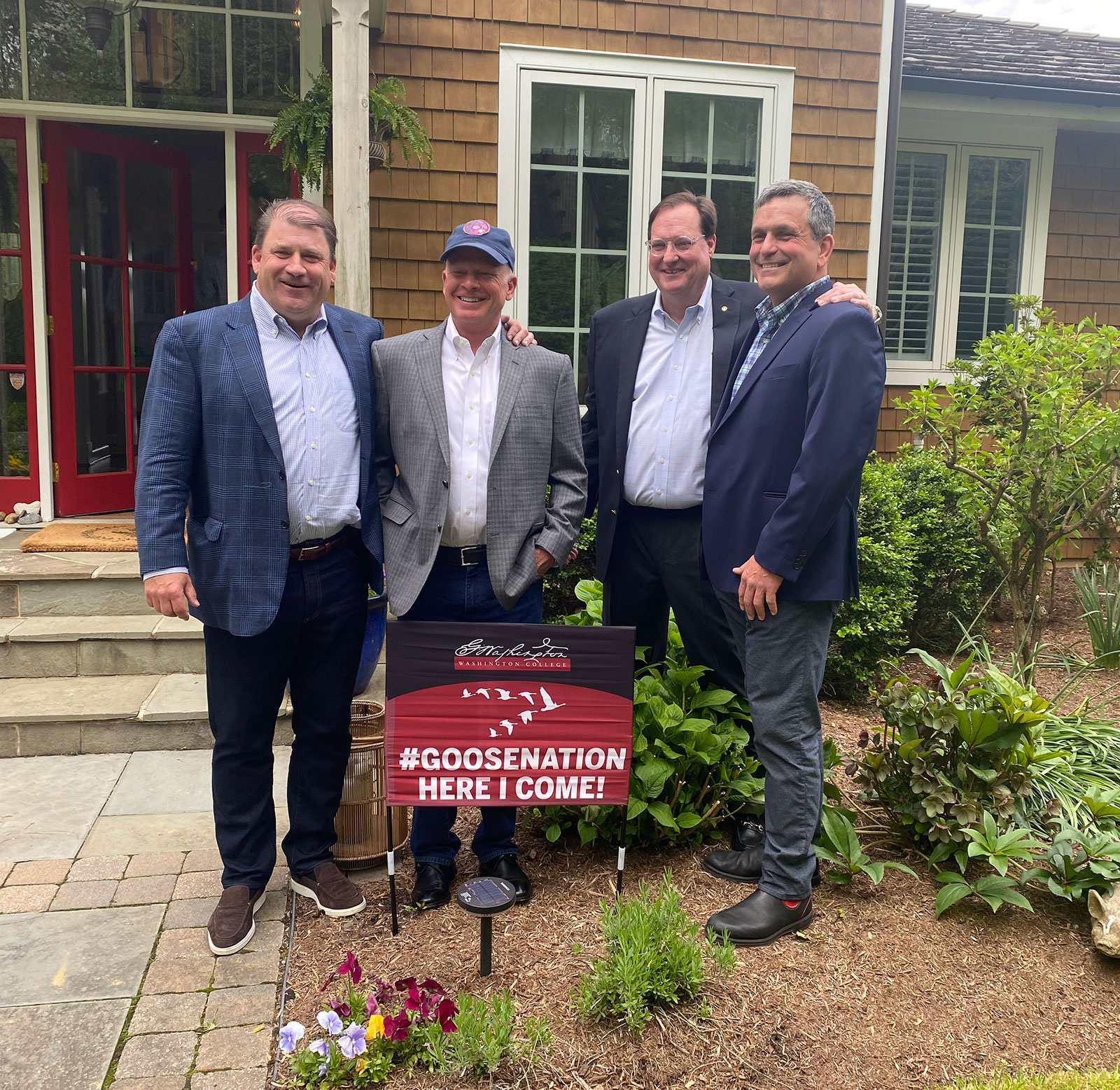 4 men setand for a photo on washington college campus