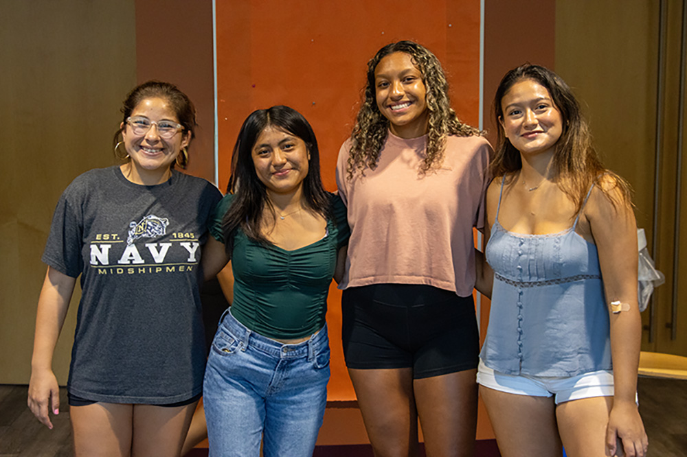 Four students pose for the camera at a LatinX Student Union event