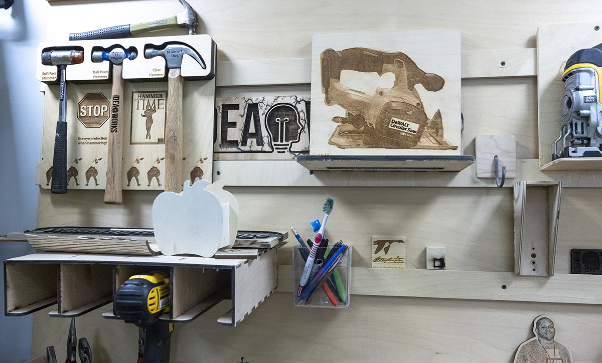 Tools hung above a workbench in a Washington College makerspace