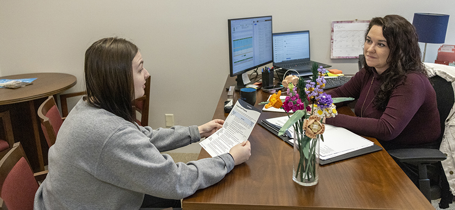 College Ave a student talks with a financial aid counselor