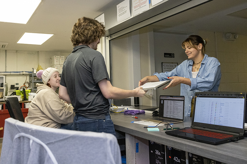 Students help a peer at the IT help desk