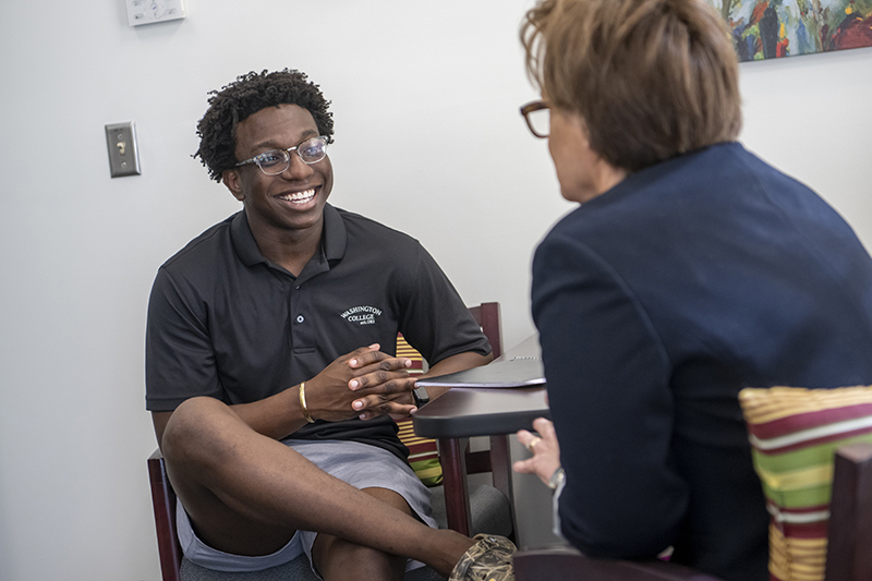 a student meeting with a staff member