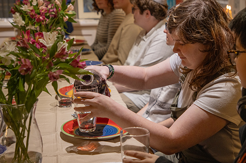 students gathered at shabbat dinner