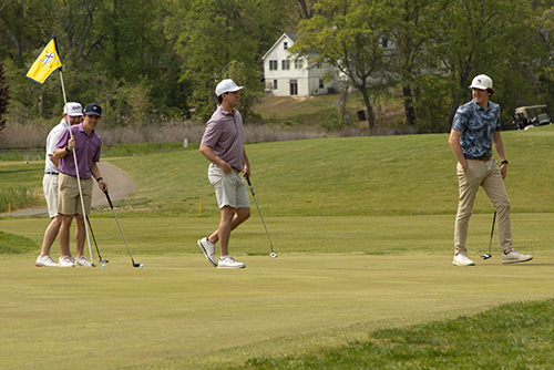 four golfers on the green