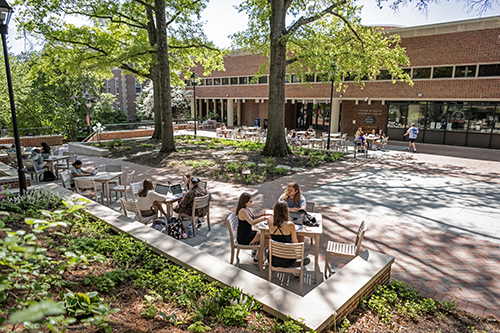 Students enjoying a spring day on the library terrace