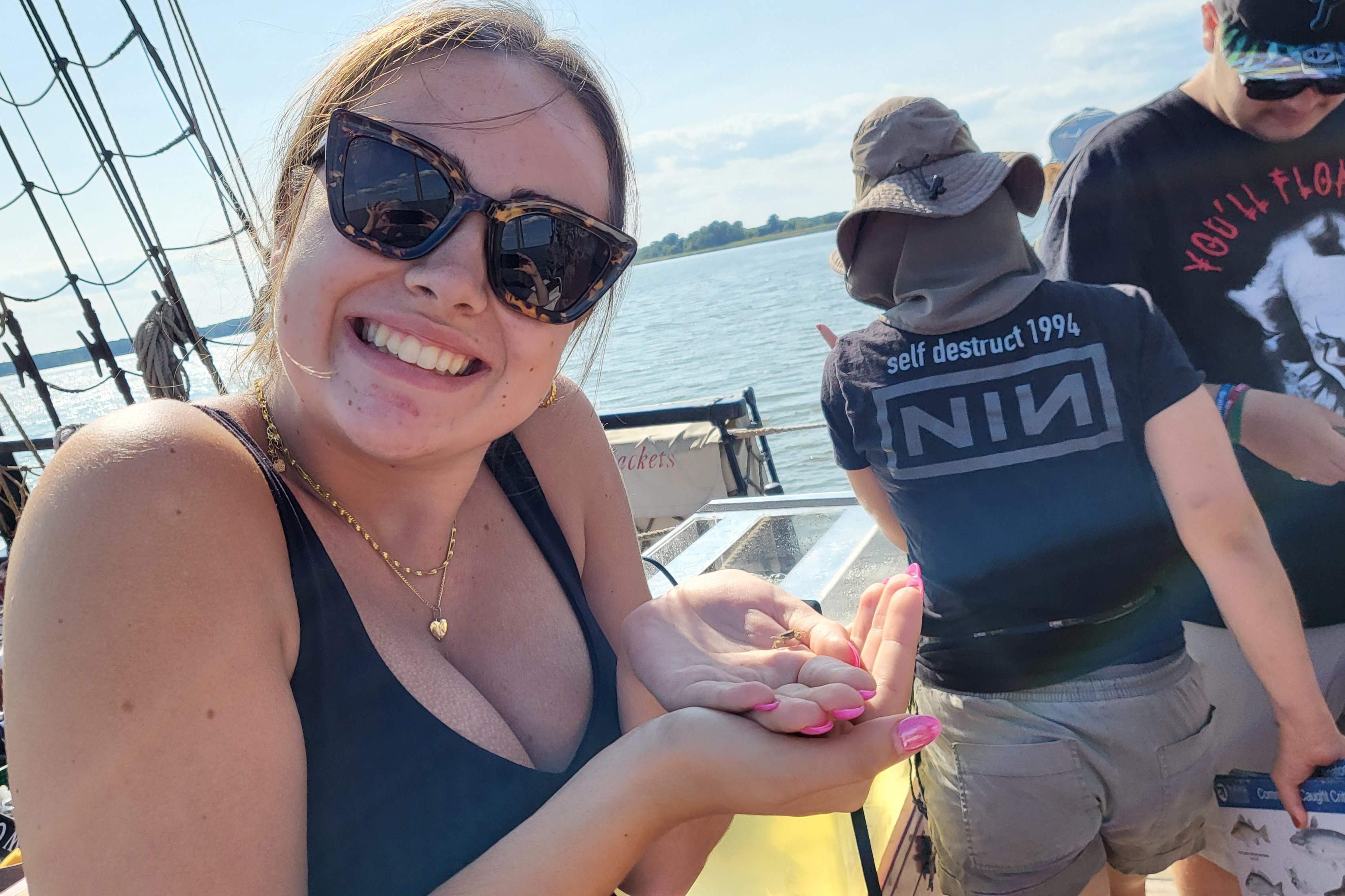 Female student holding tiny crab in her hand
