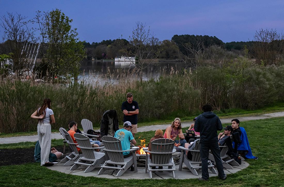 students having a bonfire at the waterfront campus
