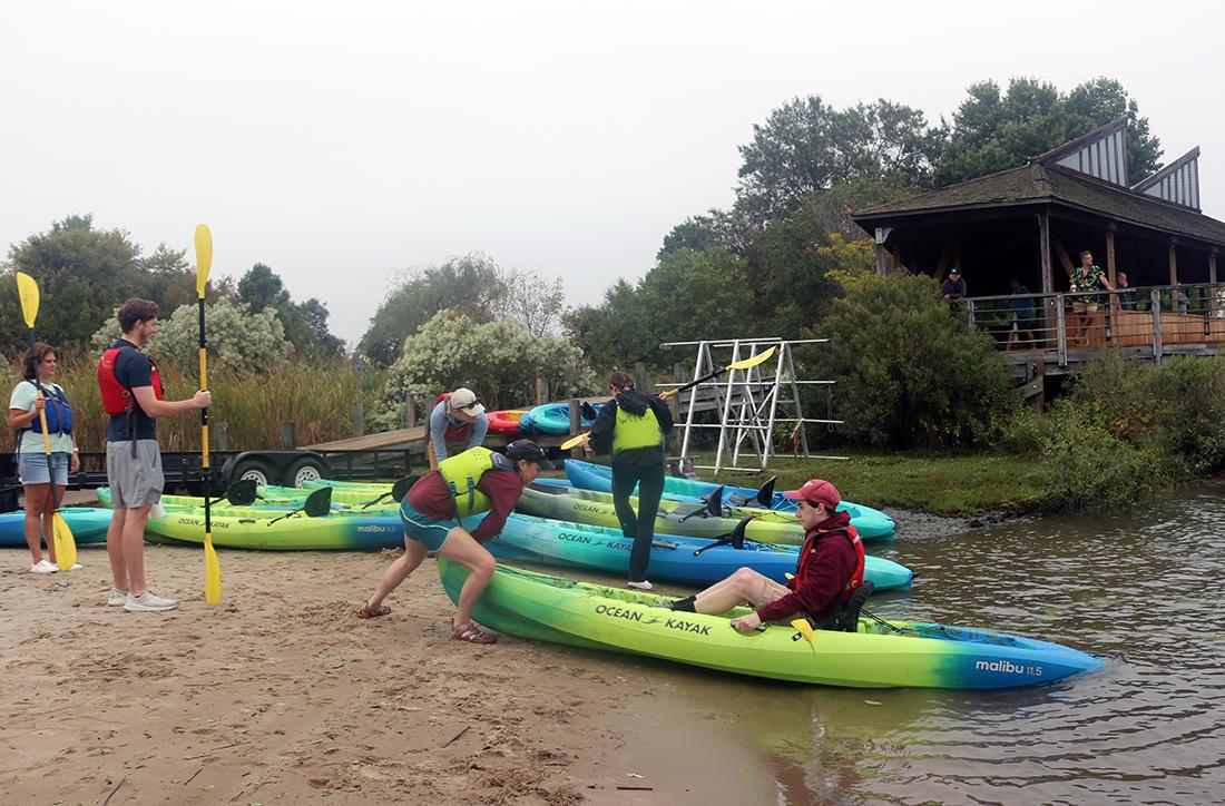 students launching kayaks at the waterfront campus